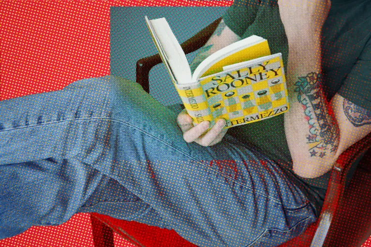 Man lounges reading Sally Rooney's book Intermezzo